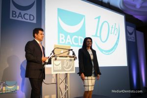 Rahul and Bhavna Doshi dental business consultants on stage